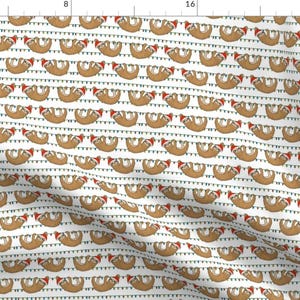 May include: A white background with a repeating pattern of brown sloths wearing Santa hats and hanging from colorful string lights.