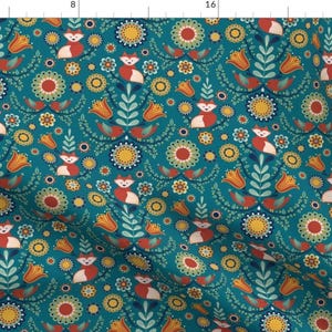 May include: Teal fabric with a repeating pattern of foxes, flowers, and birds. The foxes are red and white, the flowers are yellow, red, and green, and the birds are red and white.