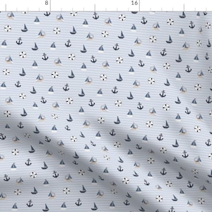 May include: A seamless pattern featuring a repeating design of blue sailboats, anchors, and life preservers on a light blue background with thin white stripes.