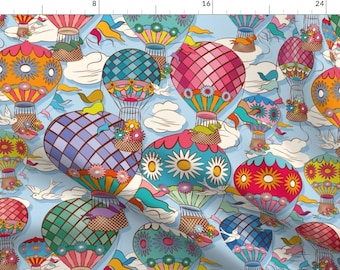 May include: A seamless pattern featuring colorful hot air balloons with floral designs against a light blue sky with white clouds. The balloons are decorated with various patterns, including checkered, striped, and floral.