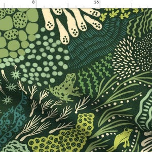 May include: A green fabric with a repeating pattern of frogs, plants, and other organic shapes. The fabric has a dark green background with light green, white, and yellow accents.