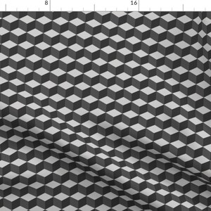 Può includere: Un motivo senza cuciture di cubi grigi e bianchi, creando un'illusione ottica di un design tridimensionale.