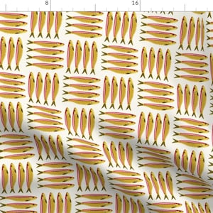 May include: A fabric pattern featuring a repeating motif of yellow and pink sardines arranged in both horizontal and vertical groupings against an off-white background. The design includes a ruler along the top and left edges showing 24 inches.