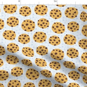 May include: A seamless pattern featuring chocolate chip cookies on a light blue background with a grid pattern. The cookies are brown with dark brown chocolate chips.