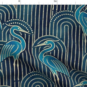 May include: A repeating pattern featuring stylized blue herons with cream-colored accents against a dark blue background. The design includes curved lines and vertical stripes, creating a vintage, art deco aesthetic.