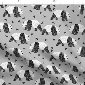 May include: A grey and white geometric panda bear pattern on a light grey background. The pattern is repeated throughout the fabric.
