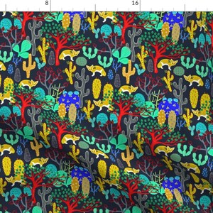 May include: A repeating pattern of colorful cacti, trees, and foxes on a dark blue background. The pattern is made up of bright colors, including red, yellow, green, and blue.