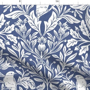 May include: A white floral pattern on a blue background with two white birds. The pattern features leaves, flowers, and berries.