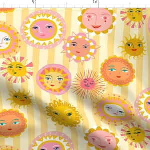 May include: A yellow and pink repeating pattern of stylized suns with faces on a yellow and white striped background.