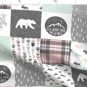 May include: A patchwork fabric design with a white background and various patterns in pink, gray, and green. The patterns include plaid, arrows, mountains, stars, trees, and moose. The fabric also includes the text "I am fearfully and wonderfully made" and "Let's sleep under the stars".