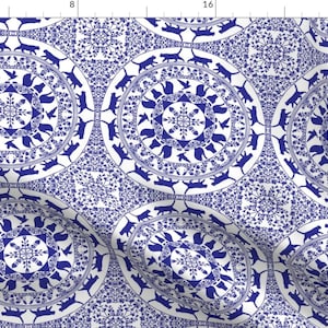 May include: A seamless pattern featuring blue and white repeating circles with a stylized snowflake design in the center of each circle. The circles are surrounded by a ring of stylized cats.