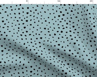 May include: A seamless pattern featuring black irregular shaped dots on a light blue background.