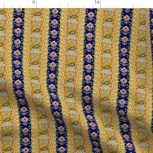 May include: A yellow and blue striped fabric with a floral pattern. The fabric has a repeating pattern of flowers, paisley shapes, and small dots.
