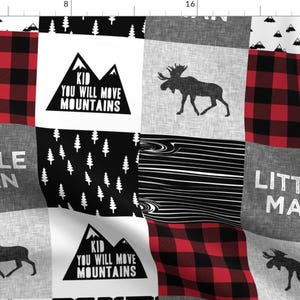 May include: A patchwork quilt in black, white and red featuring a variety of patterns including plaid, stripes and a woodland scene. The quilt also includes the text "Kid You Will Move Mountains" and "Little Man".