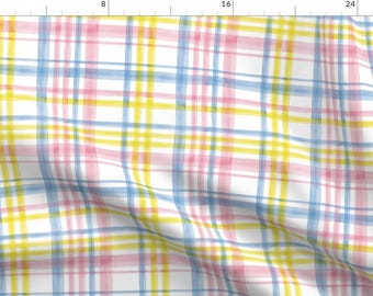 May include: A white fabric with a plaid pattern in shades of pink, yellow, and blue. The fabric has a subtle watercolor effect.