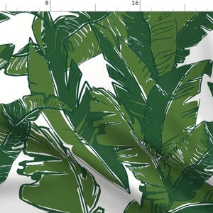 May include: A seamless pattern featuring a white background with a repeating design of green banana leaves.