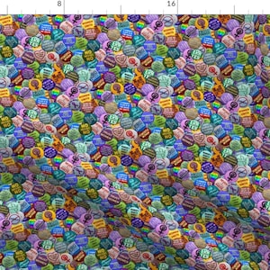 May include: A colorful fabric pattern featuring a repeating design of round buttons with various slogans and symbols. The buttons are in shades of blue, green, yellow, purple, pink, and red. Some of the slogans include "ERA YES", "NO FEAR", "PRO CHOICE", and "WOMEN'S RIGHTS ARE HUMAN RIGHTS".