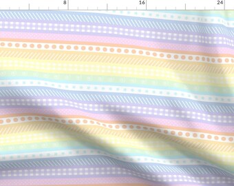 May include: A colourful fabric with a rainbow stripe pattern. The stripes are decorated with different patterns, including dots, stars, and lines. The fabric is soft and lightweight, making it perfect for a variety of projects.