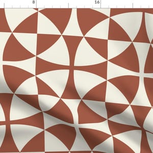 May include: A seamless pattern featuring a geometric design with alternating brown and white curved shapes. The pattern is made up of repeating squares with a cross shape in the center.