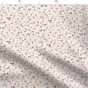 May include: A seamless pattern featuring a terrazzo design with a white background and various colored chips in shades of brown, pink, and gray.