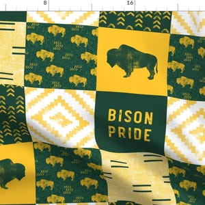 May include: A yellow and green patchwork fabric design with a bison silhouette and the text "Bison Pride".