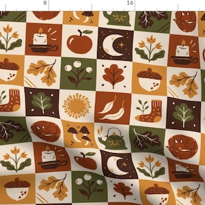 May include: A repeating pattern of autumn-themed squares. Each square features a different illustration, including a candle, apple, moon, acorn, leaf, sock, sun, and teapot. The color palette includes shades of brown, orange, green, and cream.