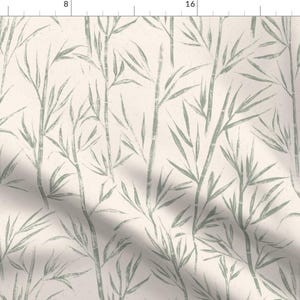 May include: A seamless pattern featuring a repeating design of green bamboo leaves on a cream background.