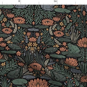 May include: A fabric print featuring a repeating pattern of green frogs sitting on lily pads, surrounded by orange water lilies, dark green aquatic foliage, and small yellow flowers against a dark background, with a ruler visible at the top and side.