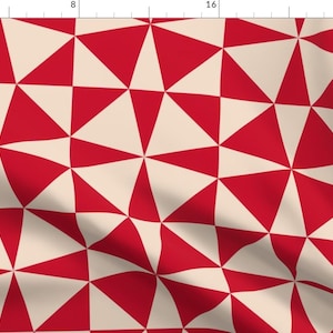 May include: A red and cream geometric pattern with a repeating triangular design. The pattern is made up of alternating red and cream triangles.