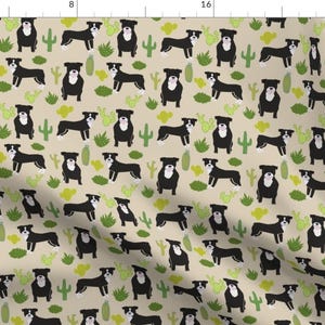 May include: A seamless pattern featuring black and white dogs with green cactus plants on a beige background.
