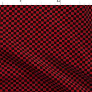 May include: Red and black checkered fabric with a small square pattern. The fabric is folded and has a slight wrinkle.