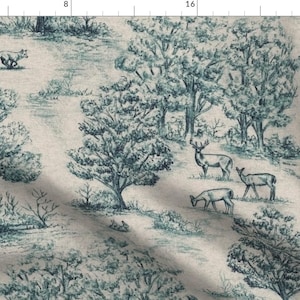 May include: Blue and white toile fabric depicting a forest scene with deer, trees, and a running fox. The fabric has a decorative border on the edges.