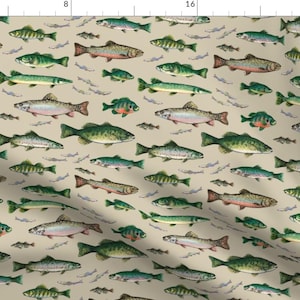 May include: A beige fabric with a repeating pattern of various types of fish in shades of green, brown, and pink. The fish are swimming in different directions and sizes.