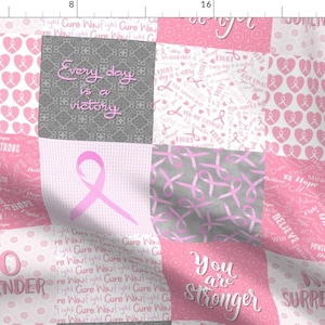 May include: A pink and grey fabric with a patchwork design featuring pink ribbons, hearts, and inspirational messages such as "Every day is a victory", "You are stronger", and "No Surrender".