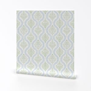 May include: A white wallpaper with a repeating pattern of blue and green stylized floral designs. The pattern is a damask style with a repeating motif of a stylized tree.