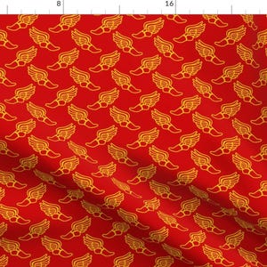 May include: Red fabric with a repeating pattern of gold winged footprints.