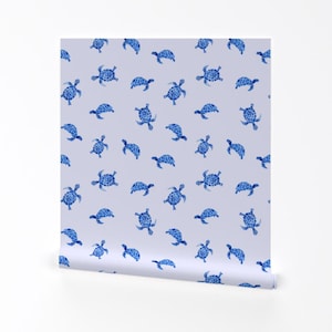May include: A seamless pattern featuring blue watercolour turtles on a light purple background. The turtles are all facing the same direction and are arranged in a repeating pattern.