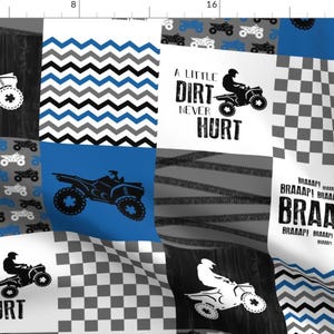 May include: A patchwork fabric design featuring a blue and white chevron pattern, a black and white checkered pattern, a gray and white tire track pattern, and a black and white wood grain pattern. The fabric also features a silhouette of an ATV with the text "A Little Dirt Never Hurt" and "BRAAAP!" in black.