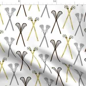 May include: A white background with a repeating pattern of lacrosse sticks and nets. The sticks are crossed and the nets are in various positions. The sticks are yellow and grey, and the nets are black.