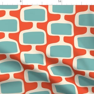 May include: A repeating pattern of teal blue and white shapes on a red background. The shapes are abstract and resemble a modern geometric design.