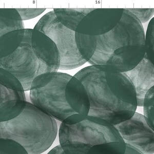 May include: A seamless pattern featuring a repeating design of overlapping circles in a deep forest green colour on a white background.