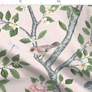 May include: A pink floral fabric with a repeating pattern of white flowers, green leaves, and a small brown bird perched on a branch. The background is a light pink.