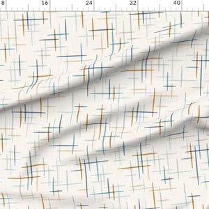 May include: A white fabric with a repeating pattern of thin, hand-drawn lines in blue, teal, and brown. The lines are arranged in a criss-cross pattern.