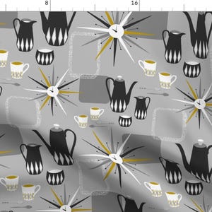 以下が含まれることがあります： グレーと白の幾何学模様で、黒と白のコーヒーポット、ティーカップ、スタイリッシュな時計がゴールドのアクセントで飾られています。パターンはデザイン全体に繰り返されています。