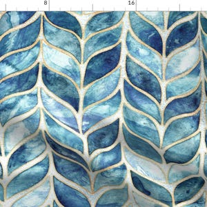 May include: A seamless pattern featuring a repeating design of blue and teal watercolor leaves with gold outlines. The leaves are arranged in a herringbone pattern.