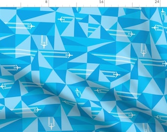 May include: A seamless pattern featuring white airplanes flying over a blue and light blue geometric background. The pattern is made up of triangles and lines.