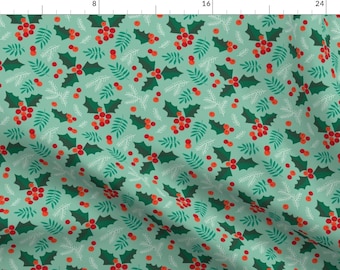 May include: A seamless pattern featuring green holly leaves and red berries on a light teal background. The pattern is perfect for holiday crafts and projects.