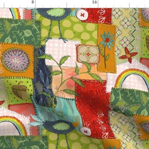 May include: A colorful patchwork fabric with a whimsical design featuring birds, rainbows, acorns, and flowers. The fabric is made up of various squares and rectangles sewn together with a visible stitch.