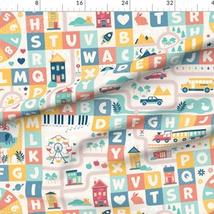 May include: A colorful alphabet playmat with a white background. The playmat features a variety of images, including houses, cars, a school bus, a rocket, a Ferris wheel, a giraffe, an elephant, a sun, a moon, a heart, a rabbit, a cat, a piano, a train, and a duck. The letters of the alphabet are scattered throughout the playmat.
