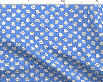 May include: A blue fabric with a white volleyball pattern. The volleyballs are repeated throughout the fabric.